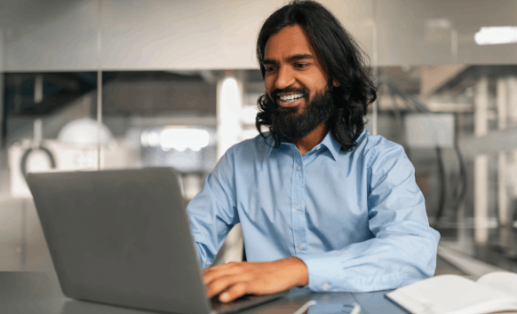 A translator checks a draft against Hindi source text, showing Hindi Translation Services in Texas with accurate delivery.