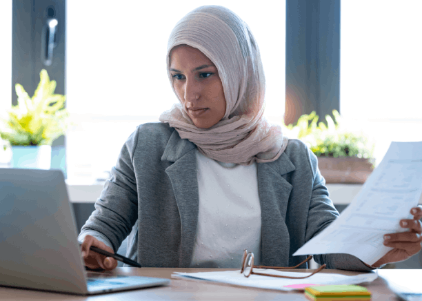 A marketing manager reviews a certified brochure draft, using Arabic Translation Services in Texas for business launches.