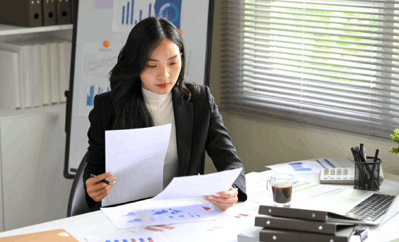 A translator reviews certified forms for Chinese Translation Services in Texas, checking USCIS-ready formatting and seals.