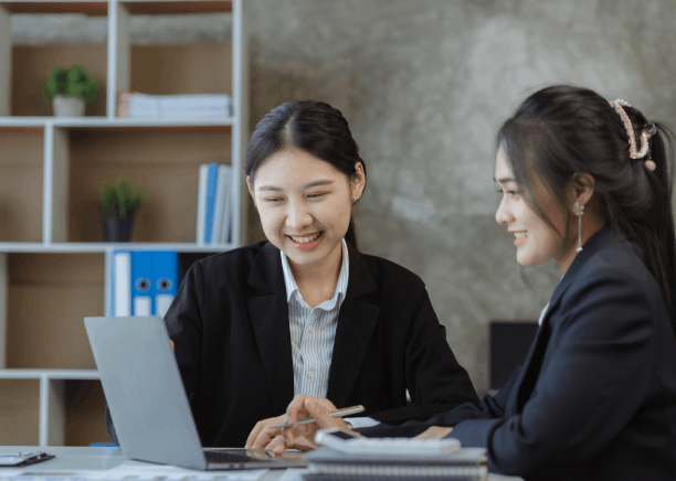 Two managers assign product listings for review at a business desk using Chinese Translation Services in Texas.