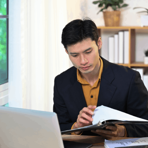 A translator proofreads a certified affidavit from Chinese Translation Services in Texas, checking names, dates, and seals.